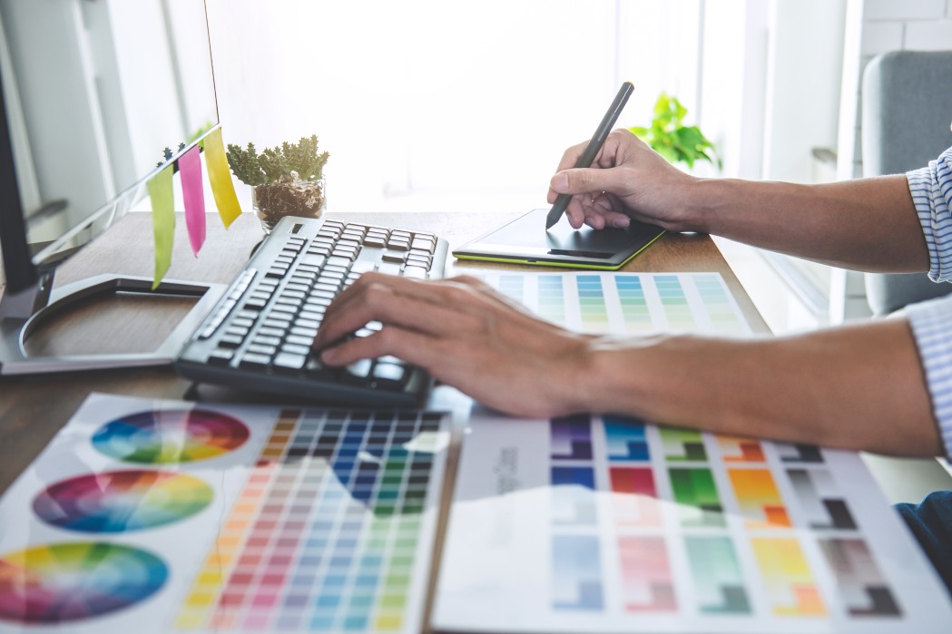 image-of-male-creative-graphic-designer-working-on-color-selection-and-drawing-on-graphics-tablet-at_t20_WxV7QX