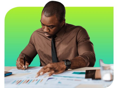 a man at a desk working on reports
